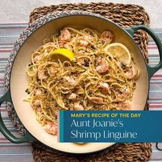 a plate of shrimp linguine with lemons and parsley on the side