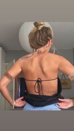 a woman with tattoos on her back