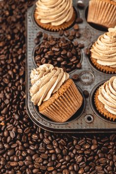 several cupcakes in a muffin tin with coffee beans