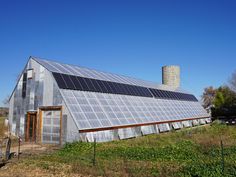 an old barn with solar panels on the roof