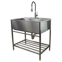 a stainless steel sink with an overflowing faucet and towel rack underneath it