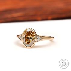 a yellow diamond ring sitting on top of a table