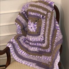 a crocheted blanket sitting on top of a chair