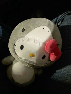 a hello kitty stuffed animal sitting on someone's lap