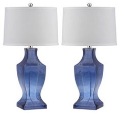 two blue vases with white lamps on them are shown in front of a white background