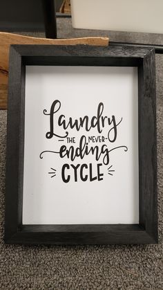 a black and white framed sign that says laundry the never - ending cycle on it