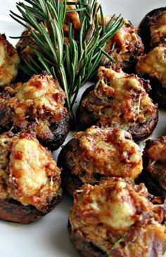 small appetizers on a white plate with rosemary sprig and seasoning