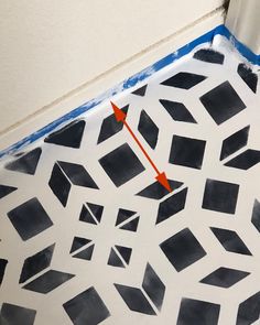 the floor is being painted with black and white squares, which are connected to an orange arrow