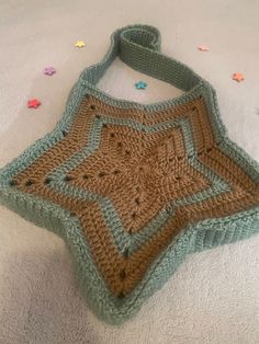 a crocheted bag sitting on top of a bed