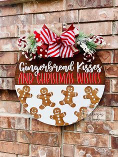 a gingerbread kisses and christmas wishes sign on a brick wall