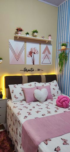 a bed room with a neatly made bed next to a night stand and two planters on the wall