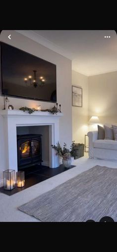 a living room filled with furniture and a flat screen tv mounted above a fire place