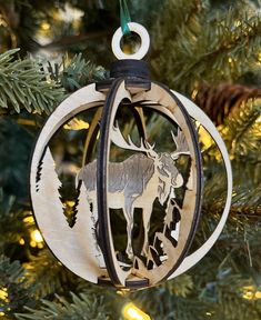 a wooden ornament hanging from a christmas tree with an elk design on it