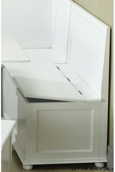 a white refrigerator freezer sitting on top of a wooden floor next to a wall