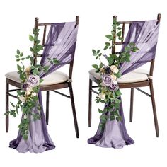 two chairs decorated with flowers and greenery