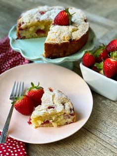 a piece of cake on a plate with strawberries