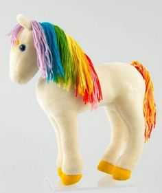 a white toy horse with multicolored manes