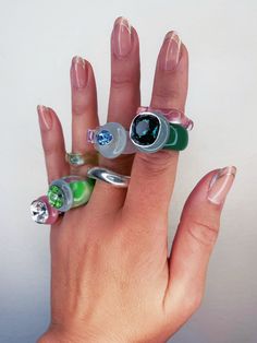 a woman's hand with several rings on it