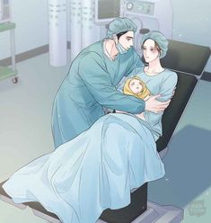 a man and woman in hospital gowns holding a baby