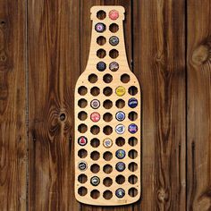 a wooden bottle opener with several different types of beer caps on it's side