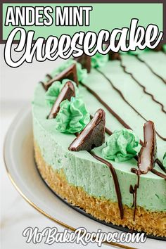 there is a cake with green frosting and chocolate decorations on the top that says cheesecake