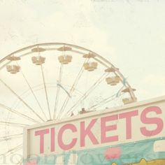 an amusement park sign with a ferris wheel in the background that says ticket's