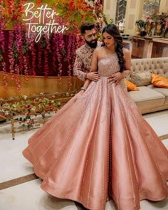 two people standing next to each other wearing pink dresses