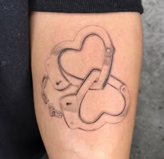 a woman's leg with a tattoo on it that has a heart and two chains attached to it