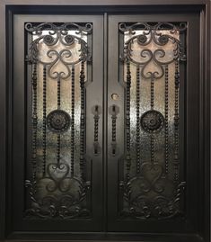 an ornate iron door with glass panels on the front and side doors, in black