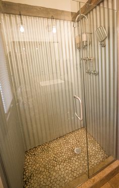 a walk in shower sitting inside of a bathroom