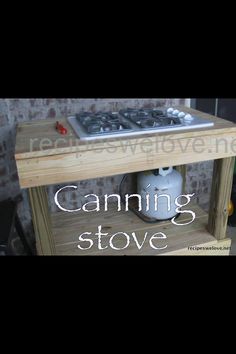 a gas stove with the words canning stove on it's shelf next to a brick wall