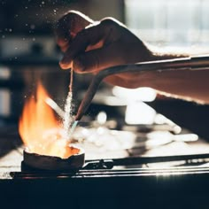 a person is stirring something on a stove