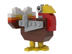 a lego model of a turkey holding a piece of bread in it's beak