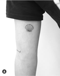 a black and white photo of a shell on the arm