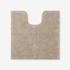 a beige bath mat on a white background