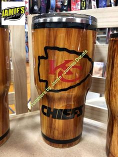 two wooden tumblers with the word chiefs on them are sitting next to each other