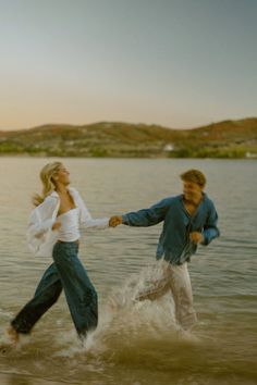 two people are running through the water