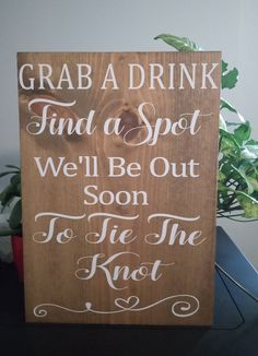 a wooden sign that says grab a drink find a spot we'll be out soon to tie the knot