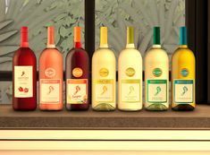 several bottles of wine are lined up on a window sill