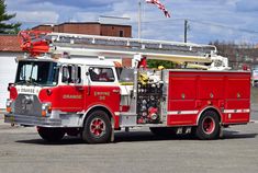 a red fire truck parked in a parking lot