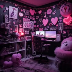 a room decorated in pink and black with hearts on the wall, computer desk and chair