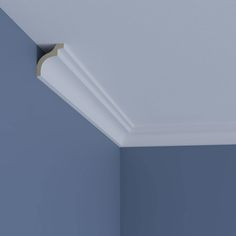 the corner of a room with blue walls and white trim on the ceiling is shown