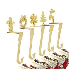 a set of six christmas themed bookends in gold and red with snowflakes on them