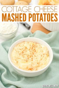 a white bowl filled with mashed potatoes on top of a green towel next to other dishes