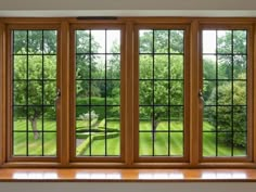 an open window in a white room with wood trim and windowsills on both sides