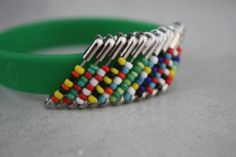 a green bracelet with multicolored beads on it