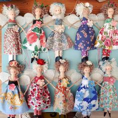 a group of dolls are hanging on a wall