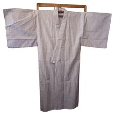 This is a cotton jacket which was made in Japan in Showa era around 1980s. A yukata (浴衣, lit. 'bathrobe') is an unlined cotton summer kimono, worn in casual settings such as summer festivals and to nearby bathhouses. The name is translated literally as "bathing cloth" and yukata originally were worn as bathrobes; their modern use is much broader, and are a common sight in Japan during summer. Though yukata are traditionally indigo and white in colour, modern yukata commonly feature multicoloured designs, and are designed to be machine washable. They are similar in appearance to the nemaki, a unisex short-sleeved kimono-like garment worn by guests at traditional inns. (Wikipedia) Dimensions: Hight total 143 cm Width total 138 cm Sleeve width 38 cm Sleeve hight 50 cm Modern Yukata, Japanese Yukata, Showa Era, Summer Kimono, Summer Festival, Cotton Jacket, Summer Cotton, Unisex Shorts, Asian Art