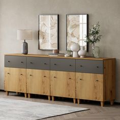 a large wooden cabinet with drawers and two mirrors on the wall next to each other