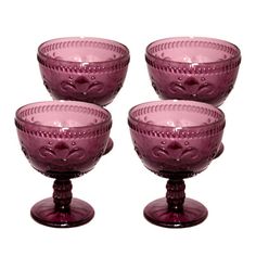 three purple glass goblets sitting next to each other